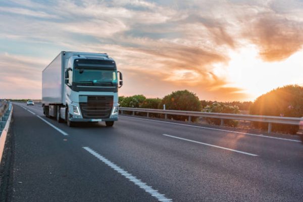 Truck with refrigerated semi-trailer moving on the highway